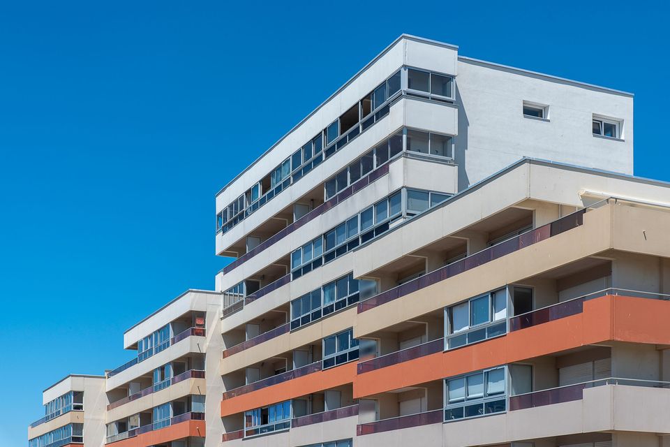 A modern apartment building under a blue sky
